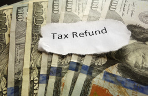 Tax Refund paper text on assorted cash